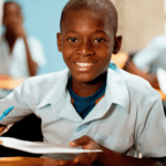 Boy in elementary school classroom showing positive learning environment