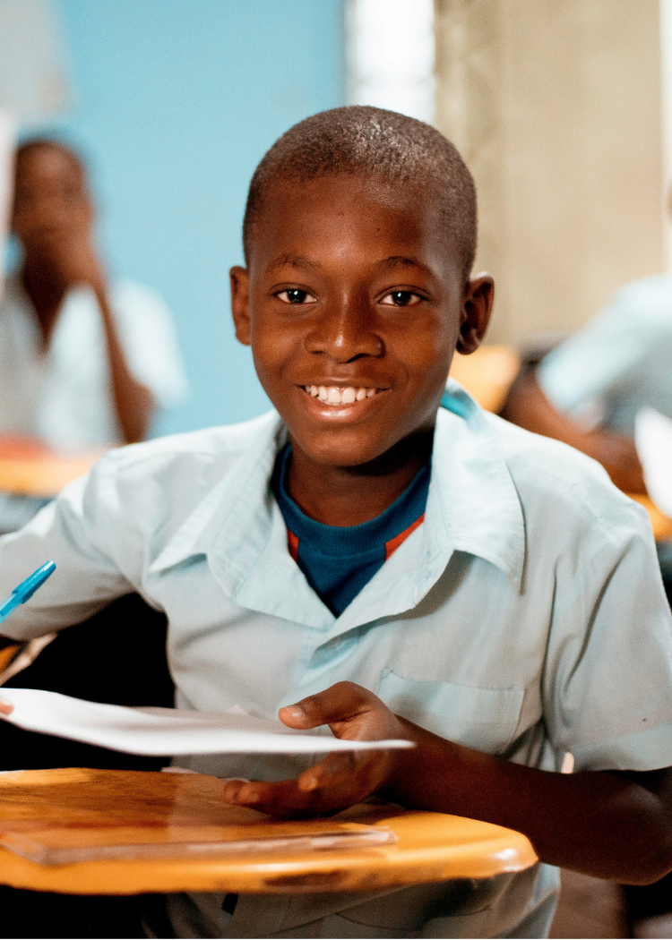 Boy in elementary school classroom showing positive learning environment