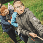 Children pulling a rope together, showing teamwork in collecting a set of resources for those who learn differently