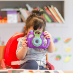 Girl in primary school looking through camera showing student empowerment