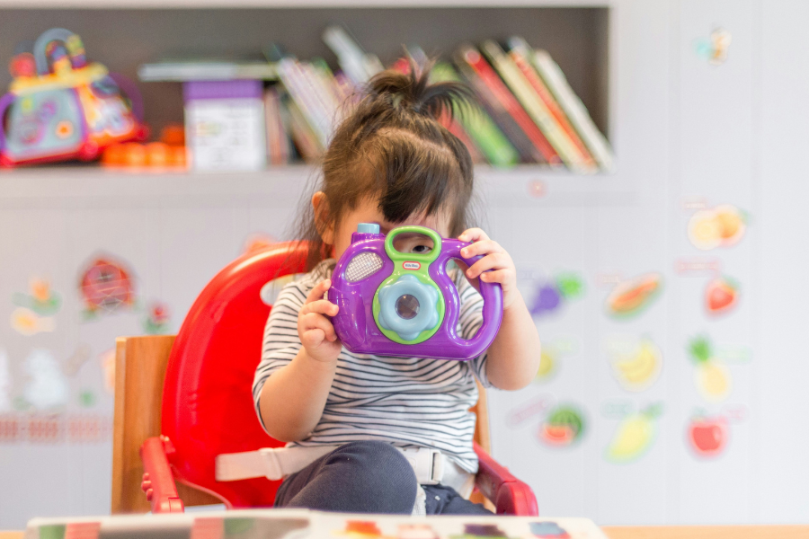 Girl in primary school looking through camera showing student empowerment