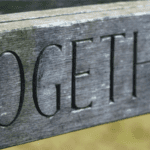 The word 'together' carved into a piece of wood showing the importance of teaching and learning together